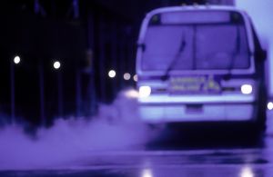 New York City bus driving on a wet road in New York City, NY