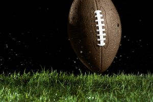 Football in motion over grass