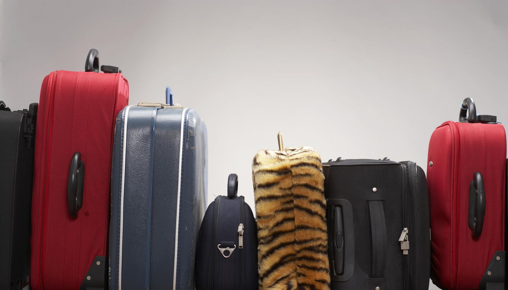 Various suitcases on conveyor belt
