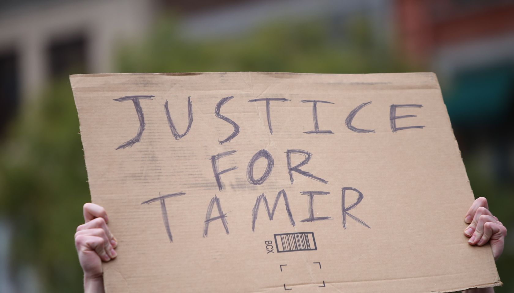 Justice for Tamir sign held aloft. Stop Mass Incarcerations...