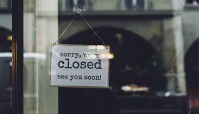 Closed Sign On Glass Wall Of Store