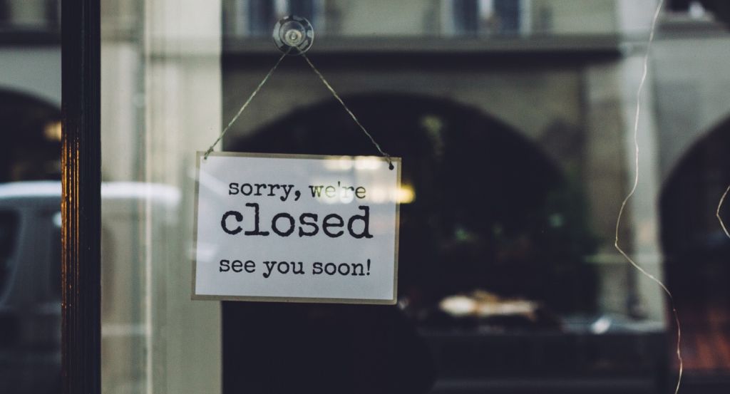 Closed Sign On Glass Wall Of Store