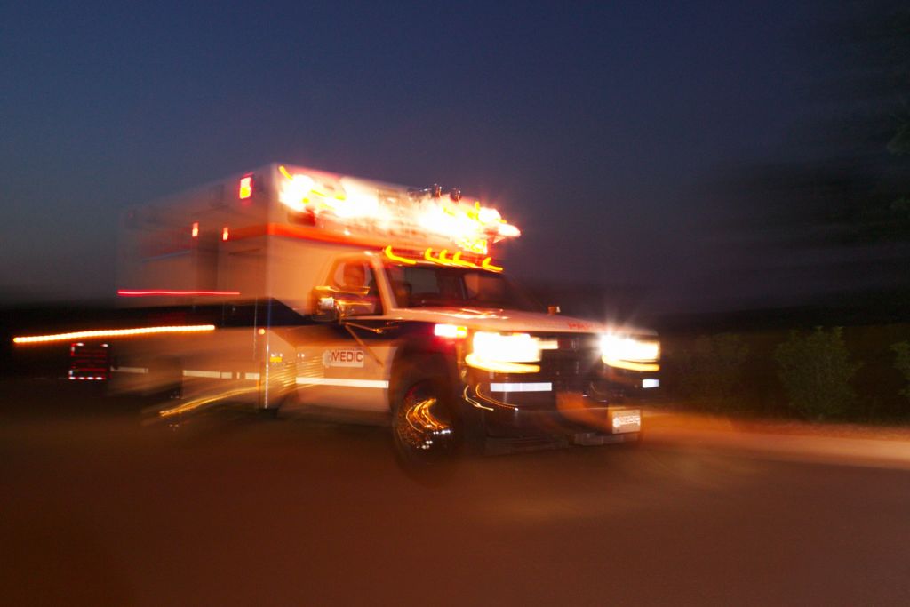 Motion blurred image of an ambulance speeding past the viewer