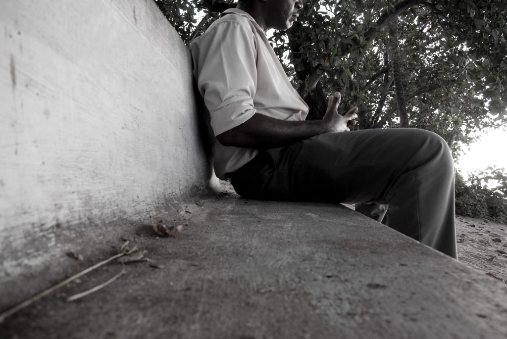 man sitting on outdoor park bench