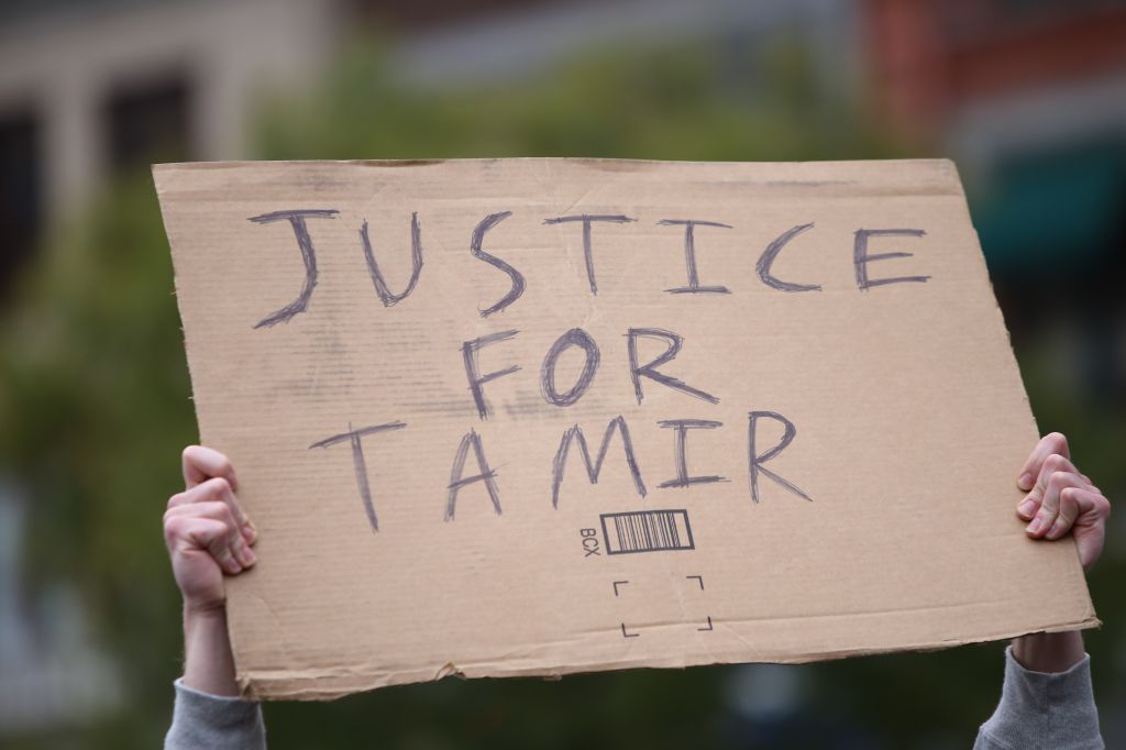 Justice for Tamir sign held aloft. Stop Mass Incarcerations...