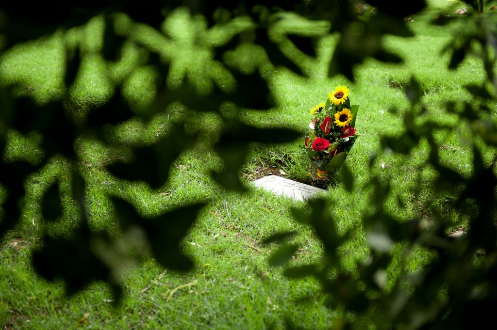 High Angle View Of Flower Bouquet On Tombstone