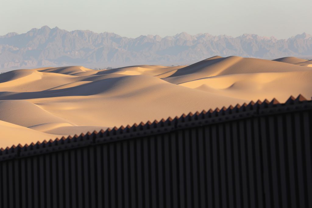 Border Patrol Agents Monitor Fence On U.S.-Mexico Border