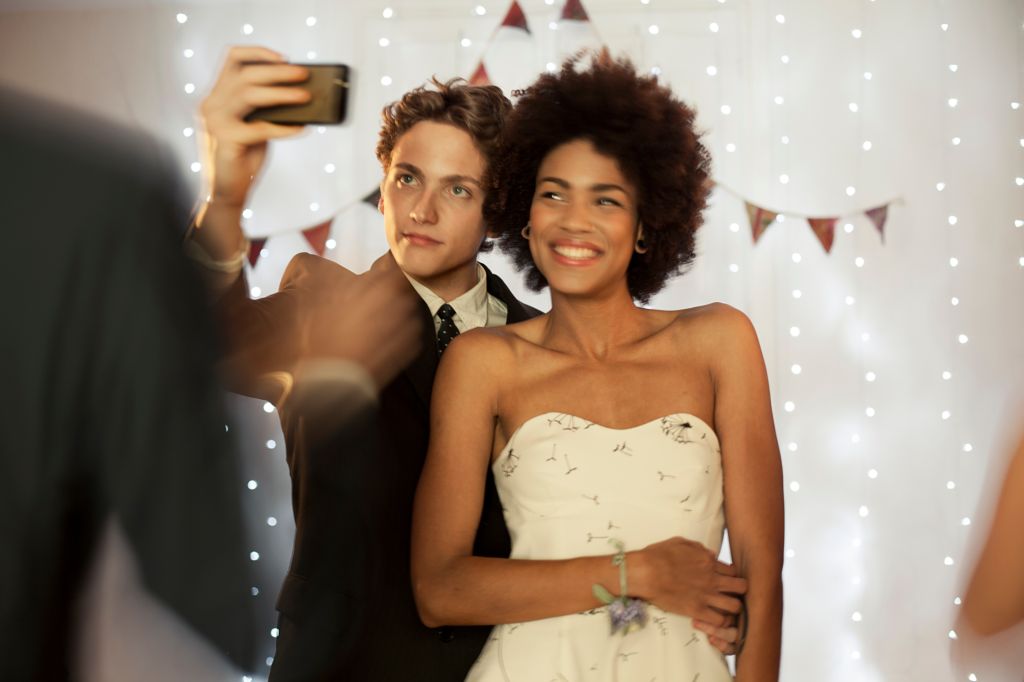 Couple taking a selfie at prom party