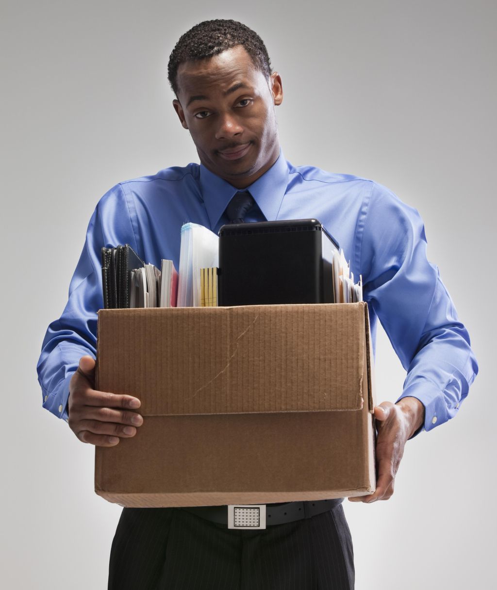 Businessman holding a box of office supplies