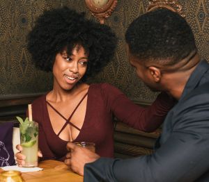 Couple sitting at table in pub