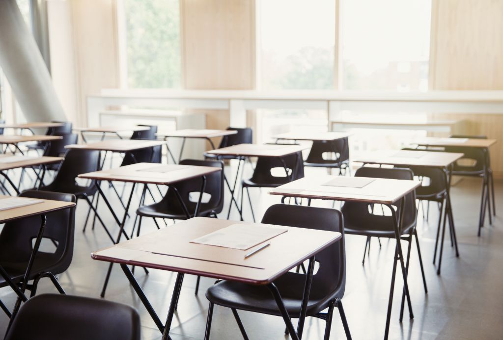 Tests on desks in empty classroom