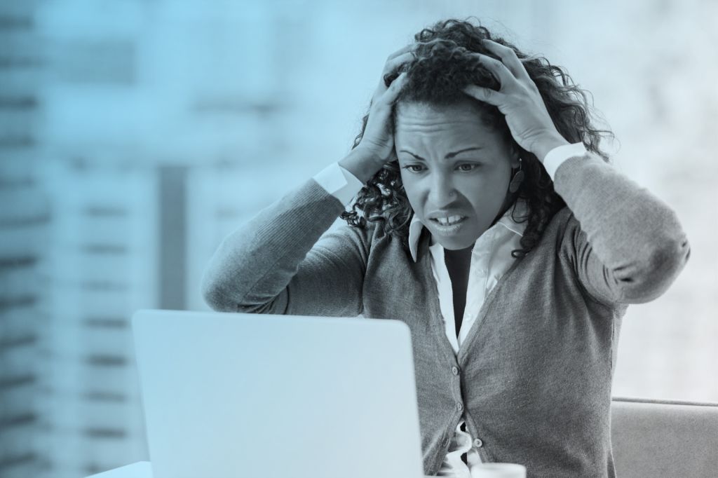 Black woman upset looking at computer