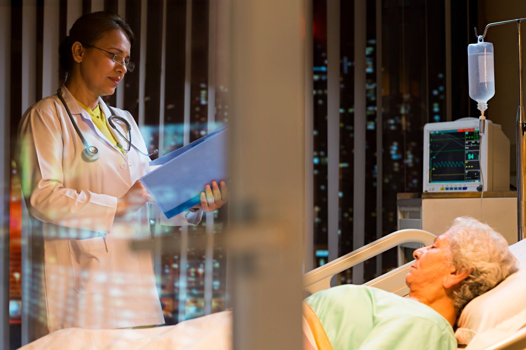 Woman patient lying on bed and doctor examining file