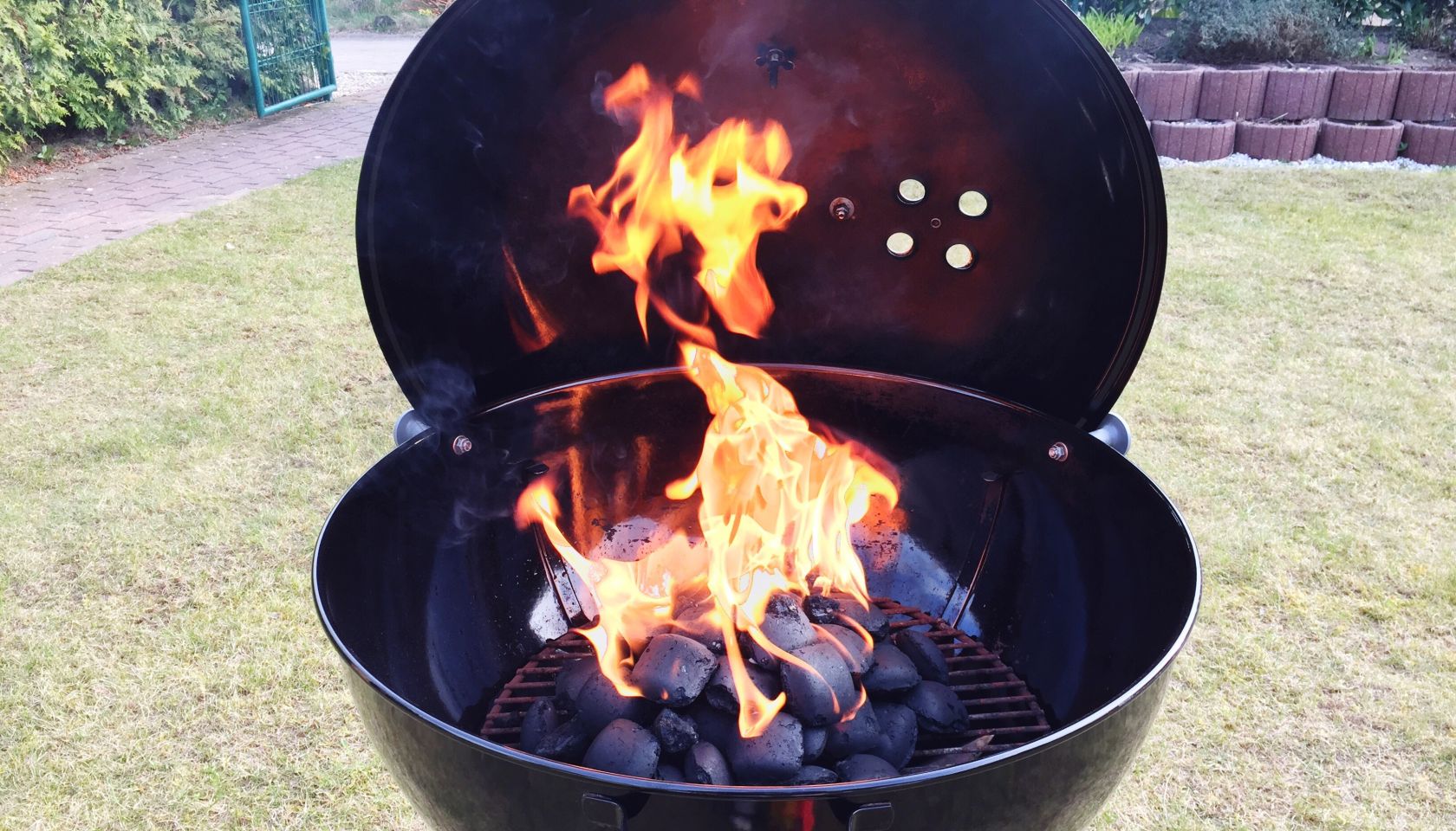 High Angle View Of Coals Burning On Barbecue Grill In Back Yard