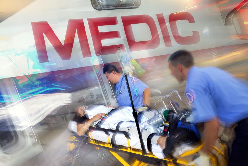 Paramedics loading patient into ambulance