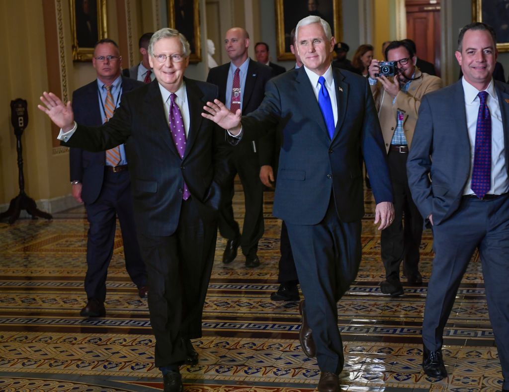 Senate Majority Leader Mitch McConnell walks through the Capitol with Vice-President elect Mike Pence, in Washington, DC.