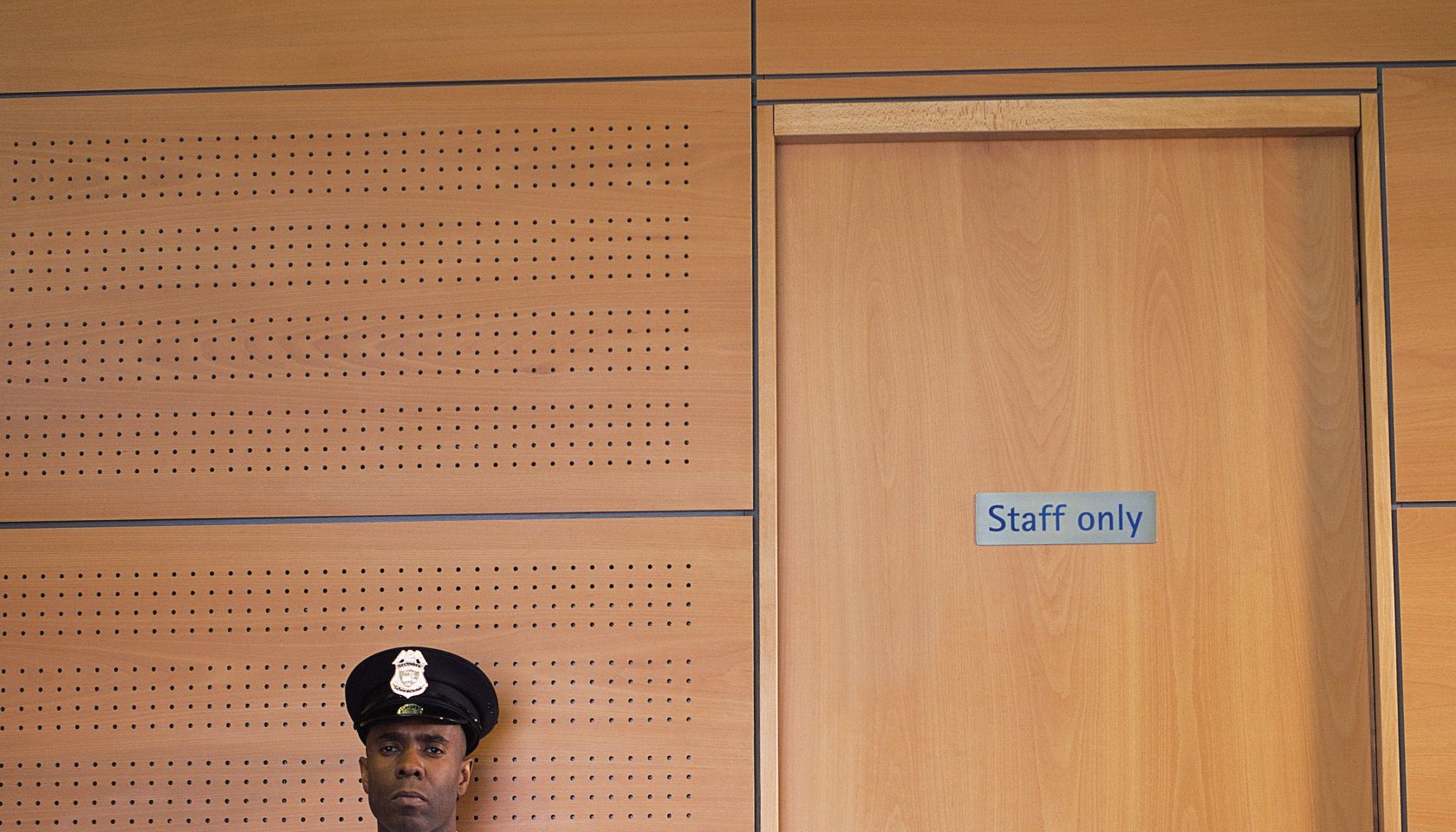 Security guard sitting by office door