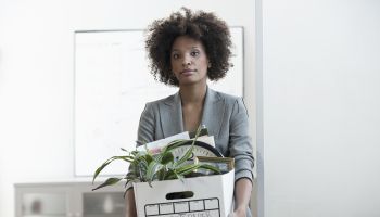 Businesswoman packing up box in office