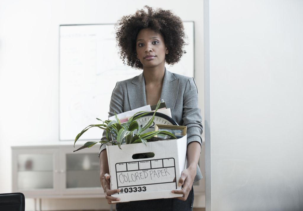 Businesswoman packing up box in office