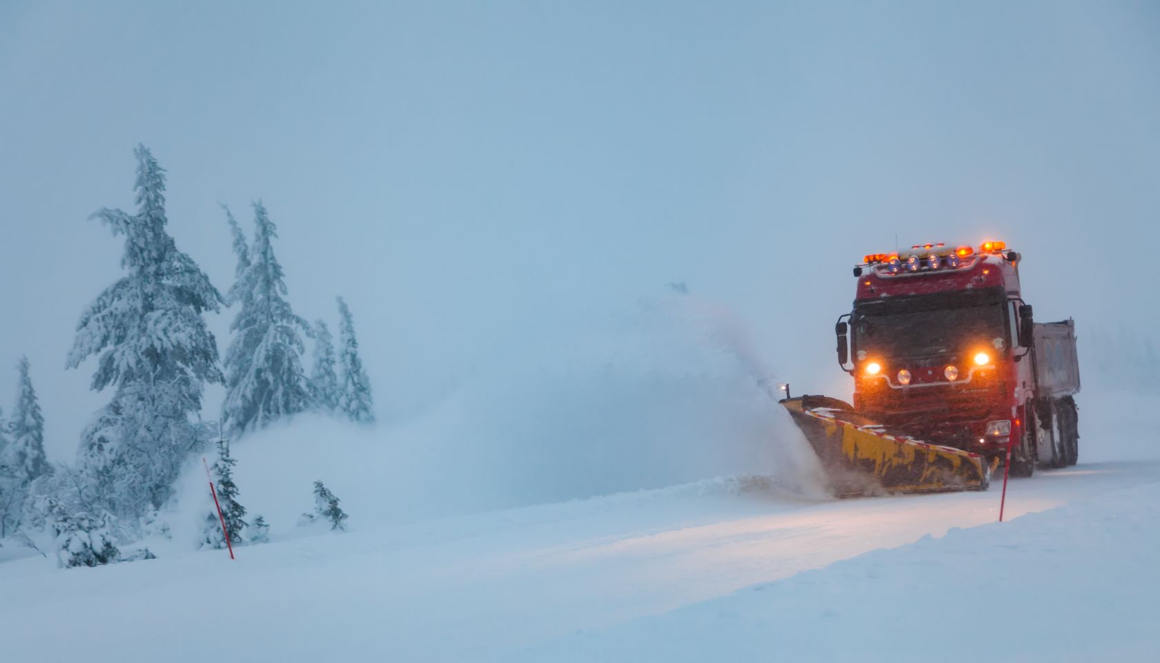 Snowblower grader clears snow covered country road