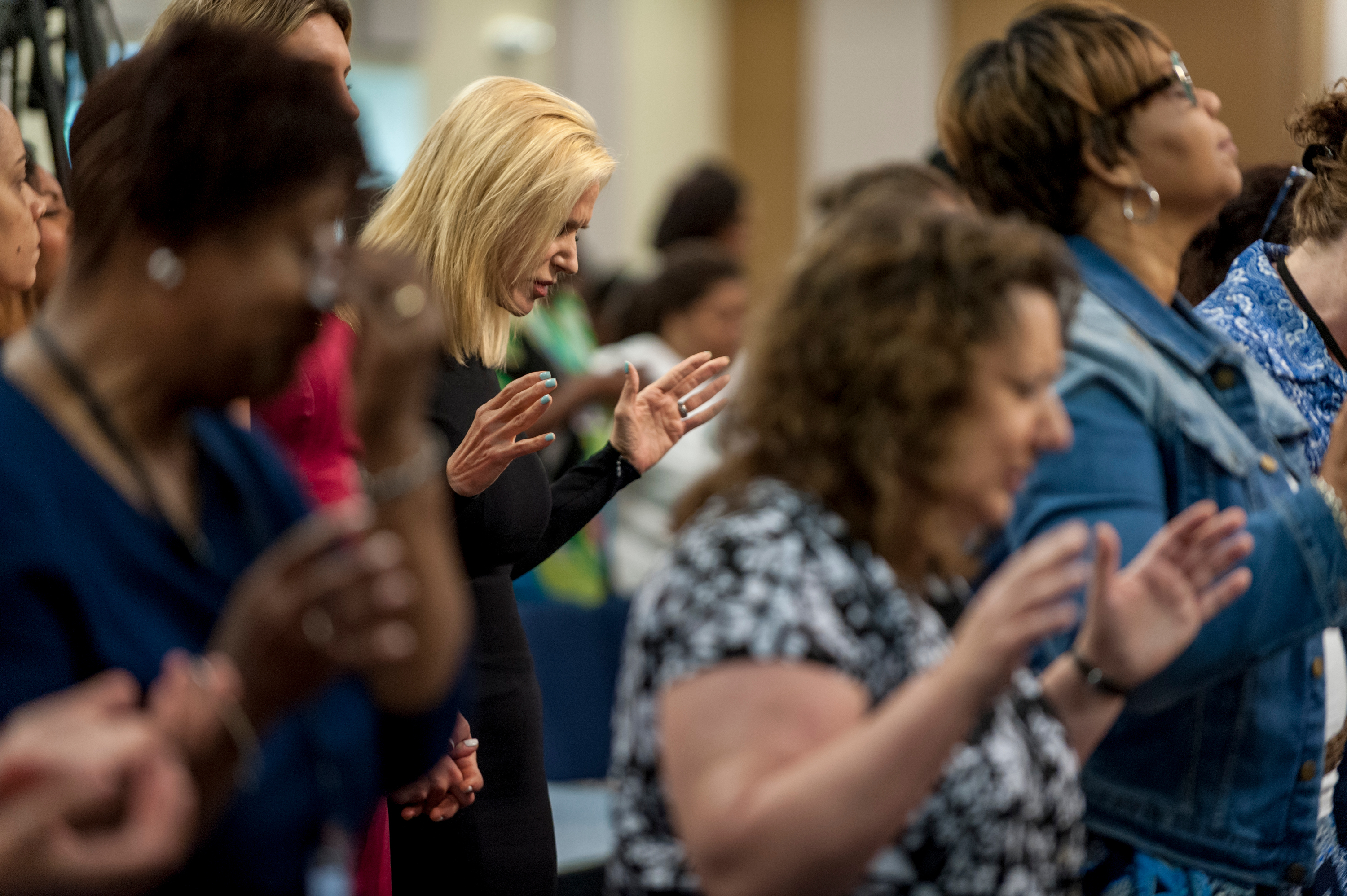 Visiting Pastor Paula White, a Pentecostal Christian televangelist, prays before giving a sermon to the congregation at Hope Christian Church...