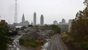 Industrial railway leading to the cloudy city skyline
