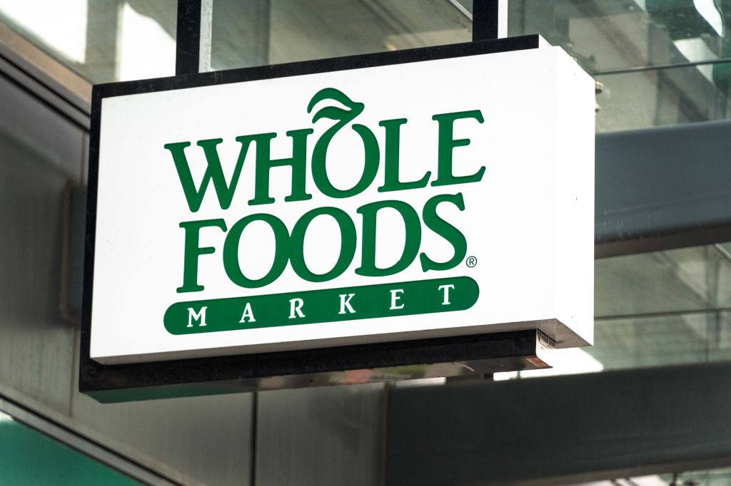 Whole Foods sign hanging on a store entrance in Yonge Street...