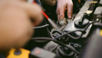 Close-Up Of Hands Repairing Car Engine