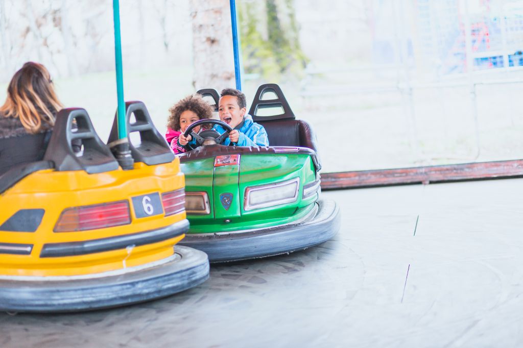 Single mother with children playing in amusement park