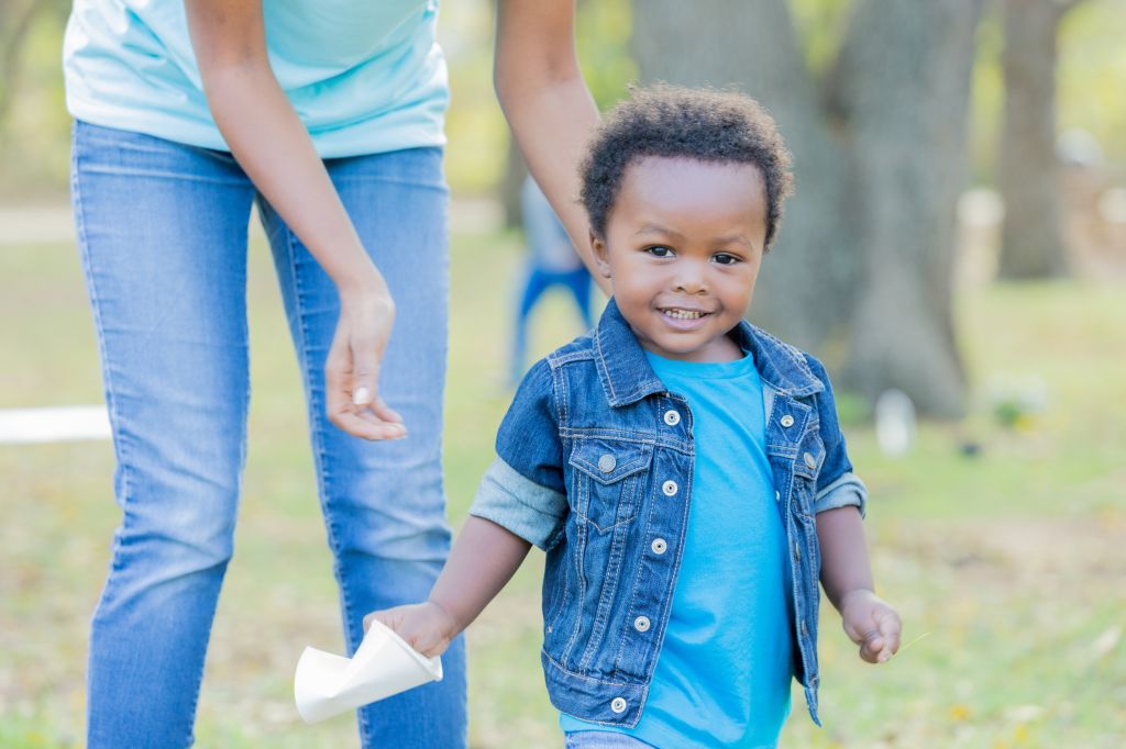 Adorable toddler helps his his mom with community cleanup