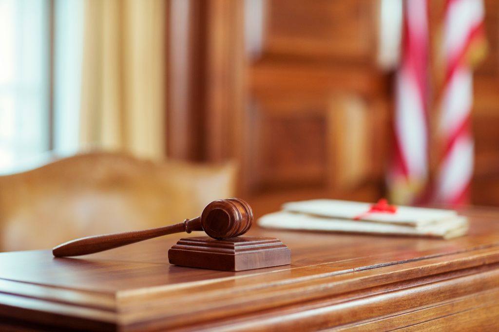 Gavel laying on judges bench in courtroom