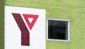 YMCA logo or sign in an old brick wall building. The Young...