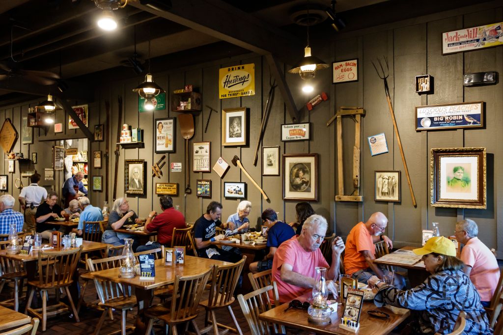 Customers dining inside Cracker Barrel Country Store restaurant.