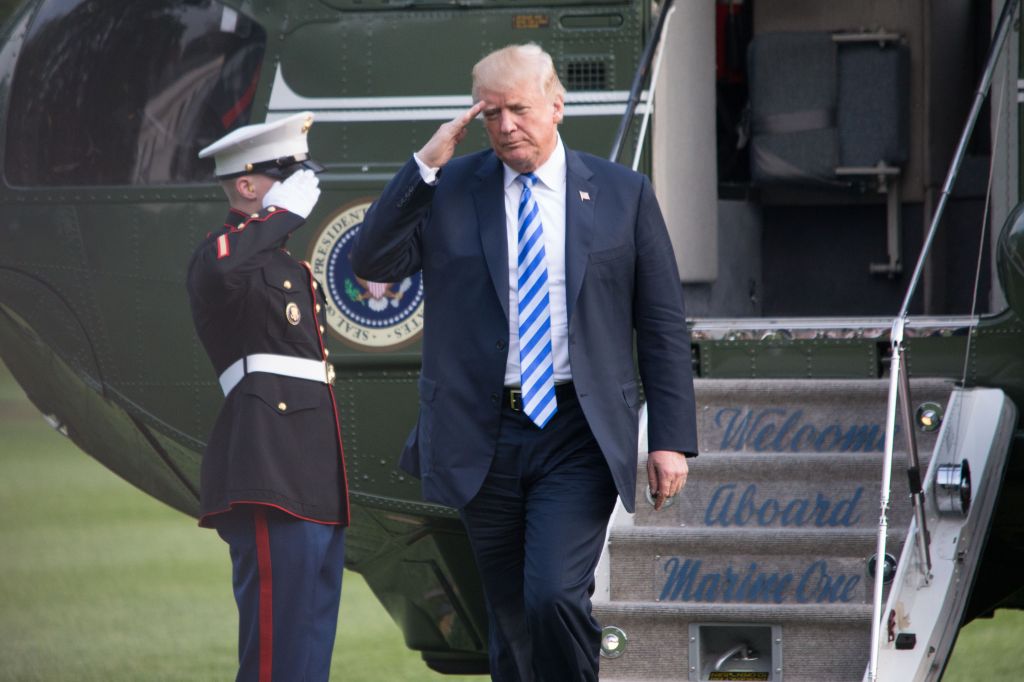 President Donald Trump disembarks Marine One after returning...