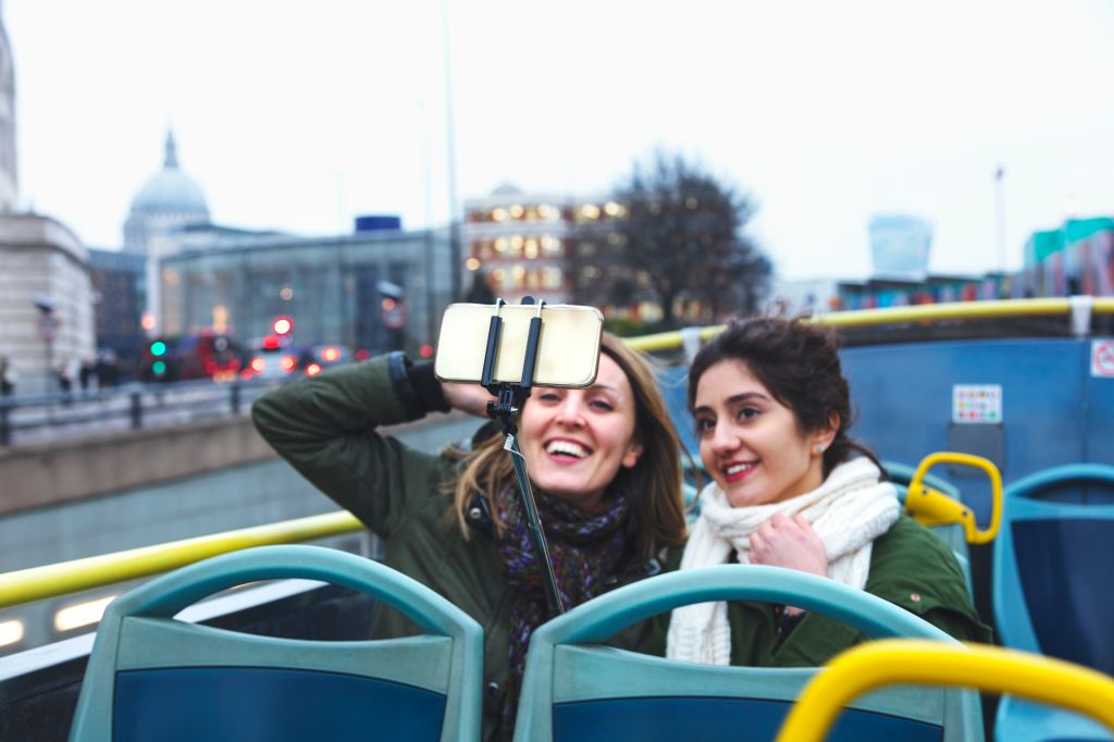 Tourist friends take a bus tour in London