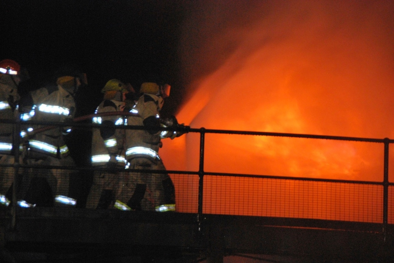 Firefighters Spraying Water On Fire