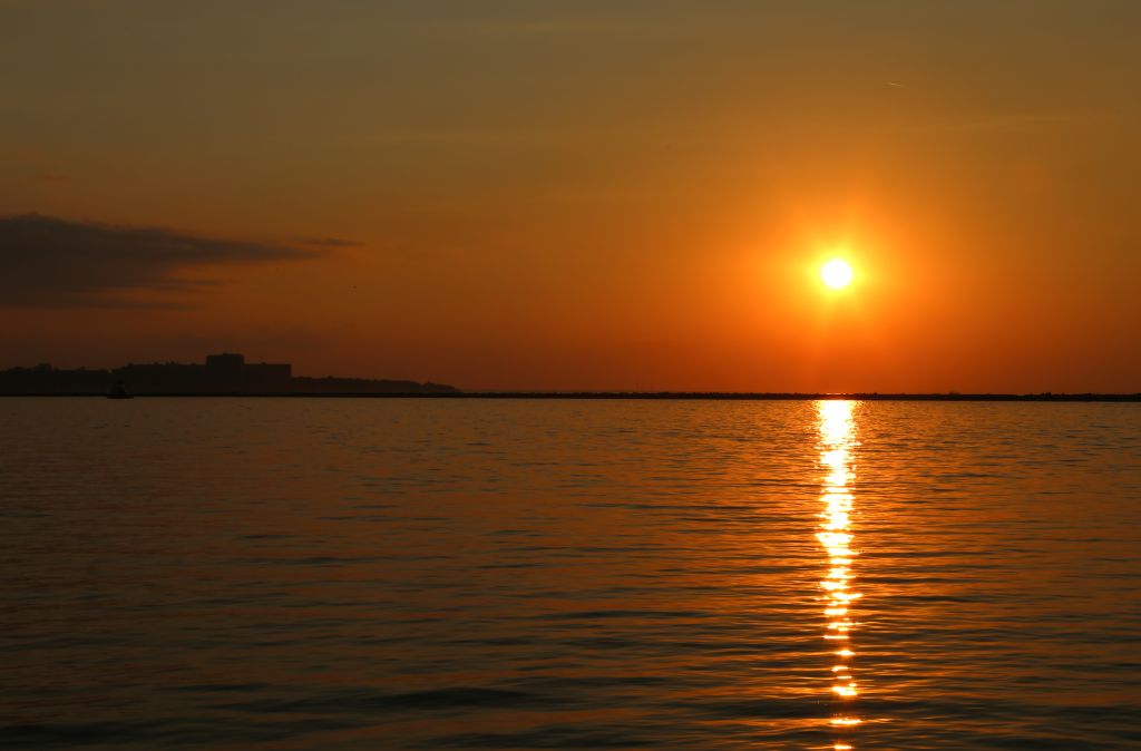 Orange colored sunset over Lake Erie, Edgewater Park, Cleveland, Metroparks, Cleveland, Ohio, USA