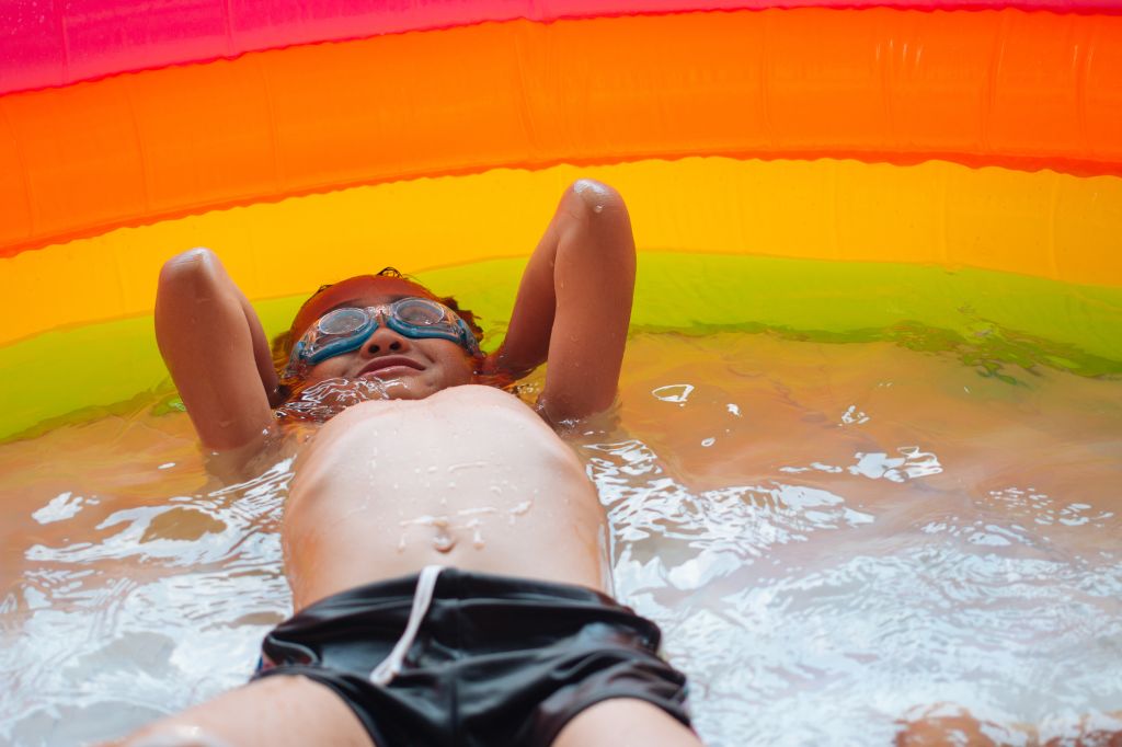Shirtless Boy Relaxing In Wading Pool