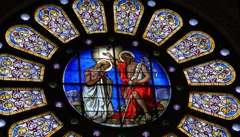 Baptism of Jesus, stained glass in rose window of cathedral of Basel, Switzerland
