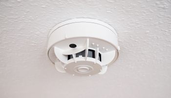Low Angle View Of Smoke Detector On Ceiling
