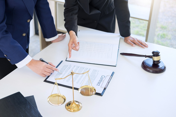 Midsection Of Male Lawyers Discussing Over Contract In Office