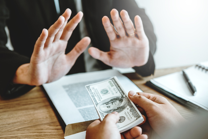 Cropped Hands Of Customer Giving Bribe To Agent