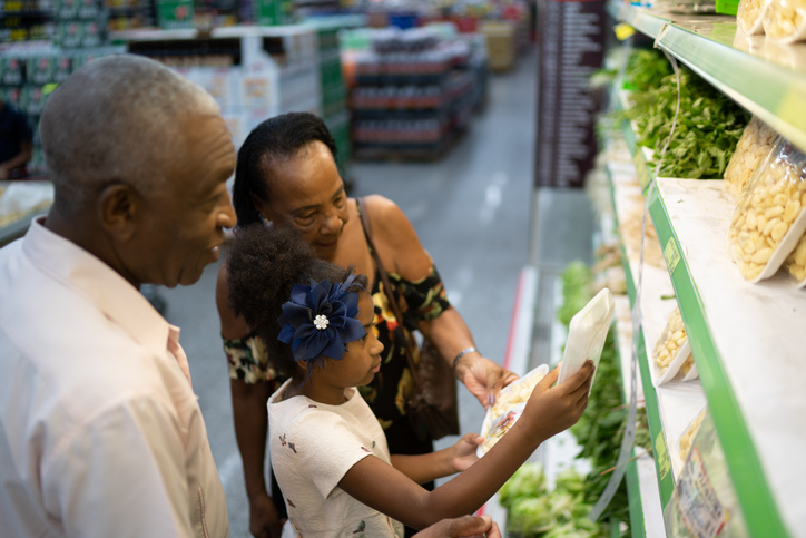 Family choosing vegetables at grocery store