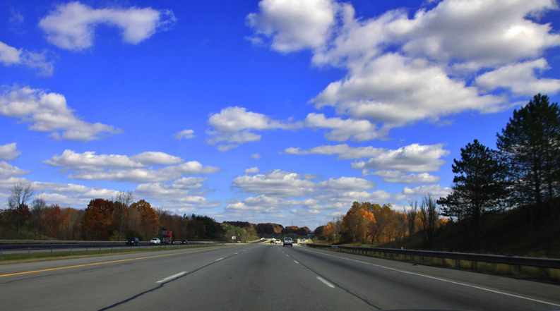 Rural paved Highway under the blue sky