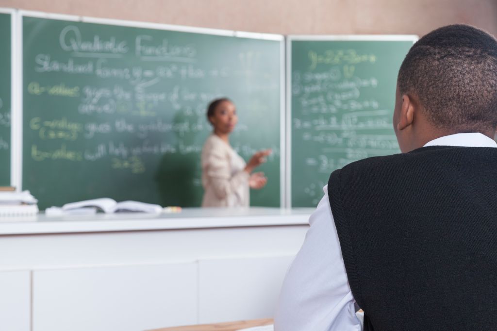 A female teacher teaching mathematic equations in the classroom, Cape Town, South Africa