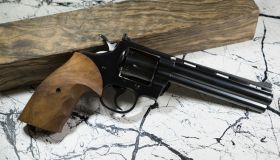 Magnum revolver with Bullet and leather background