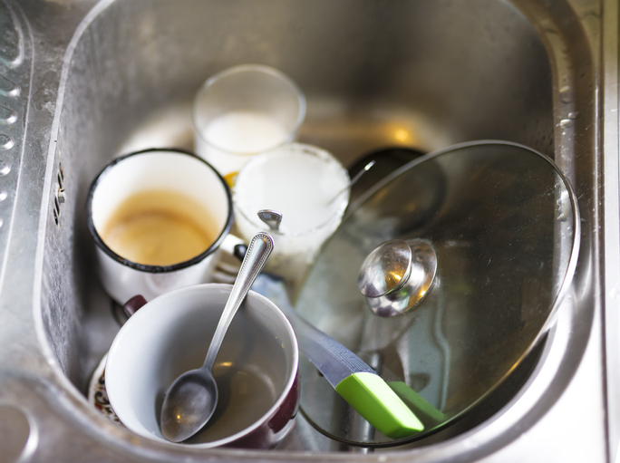 Dirty washing up in sink at the kitchen