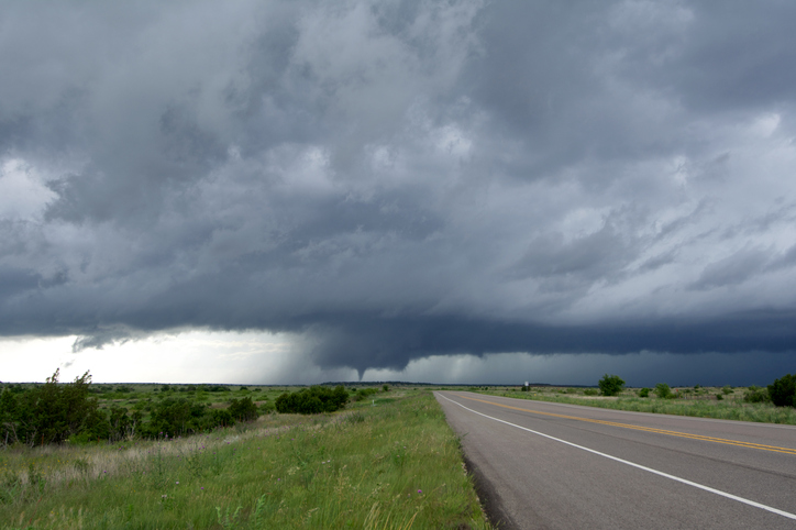 Diminishing perspective of road and tornado storm clouds, Guthrie, Texas, USA