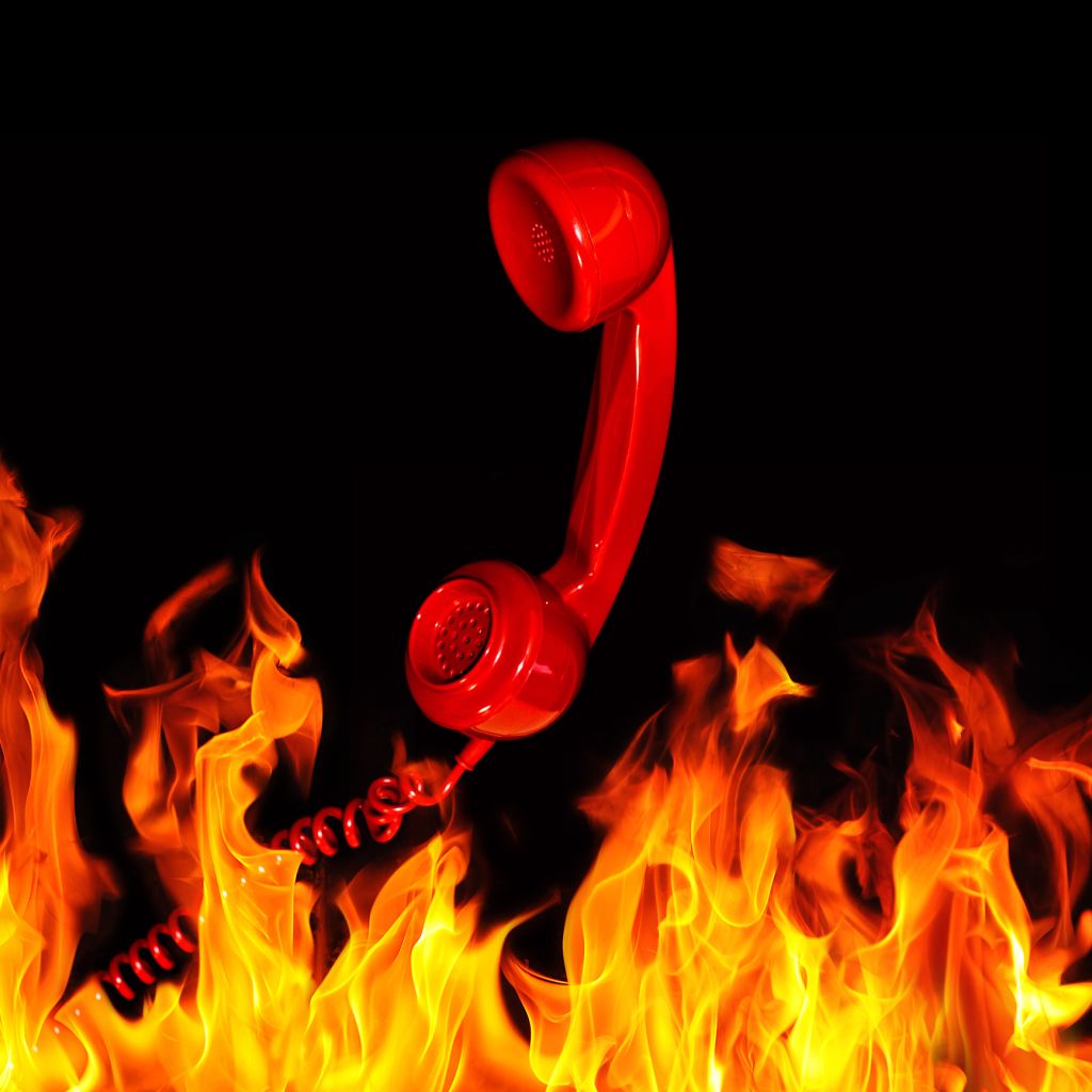 Retro red telephone handset and flames