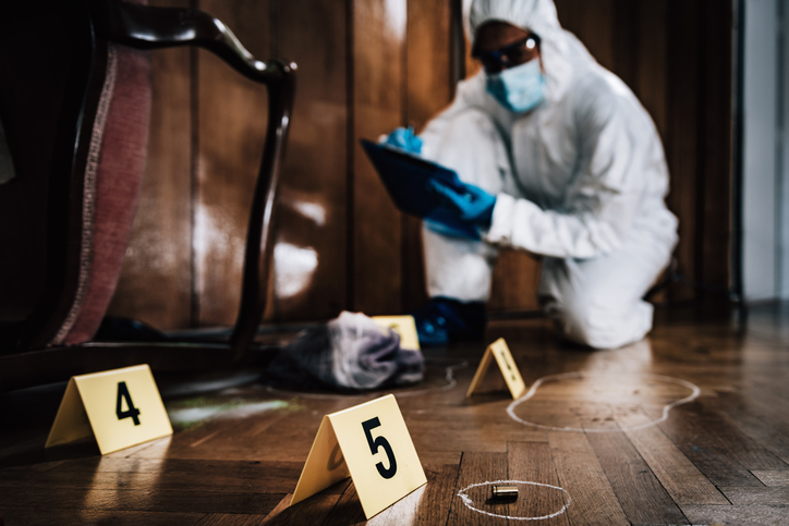 Scientist Investigating At Crime Scene
